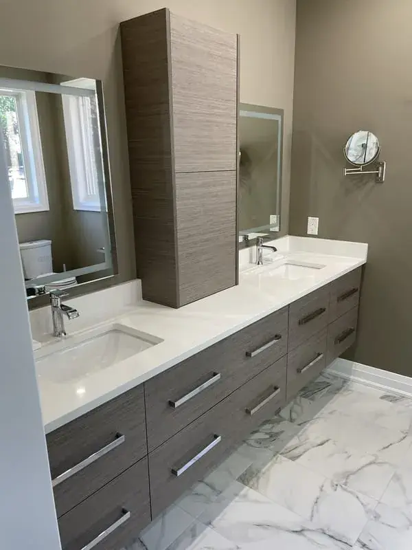 Long floating vanity with a tall cabinet over a marble look floor
