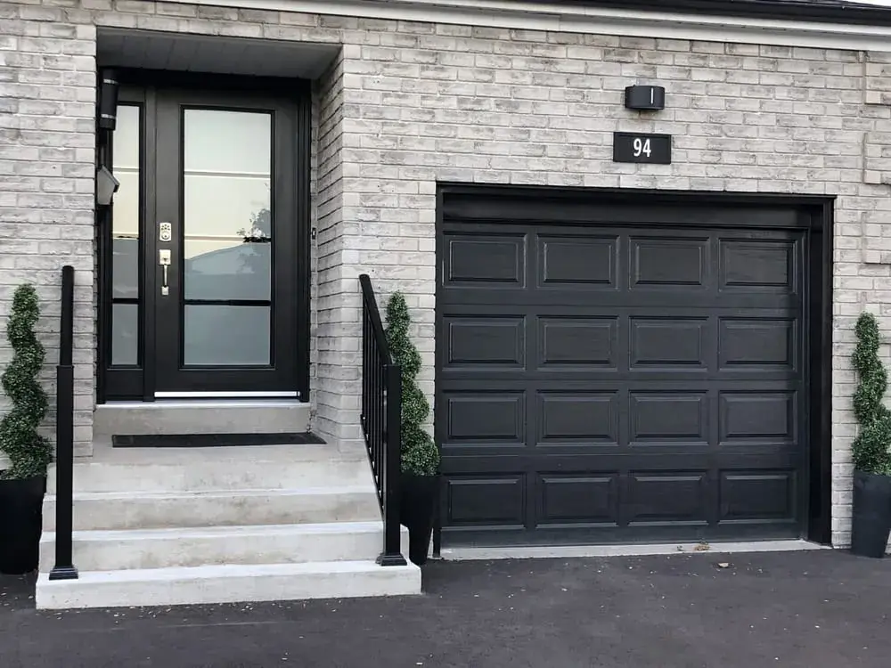 A light brick Hamilton home with a new black front door