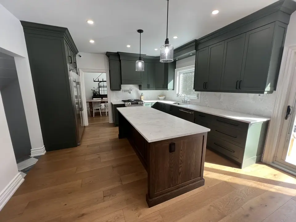 Kitchen: dark green cabinets, walnut island, wide-plank floor